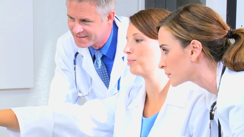 Doctors analyzing patient data.
